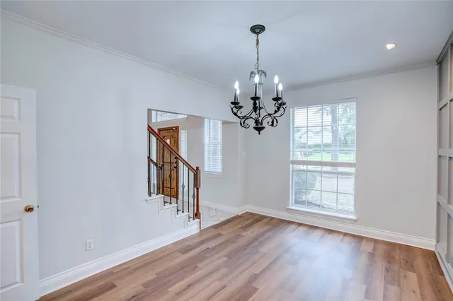 a view of a livingroom with a hardwood floor ceiling fan and window