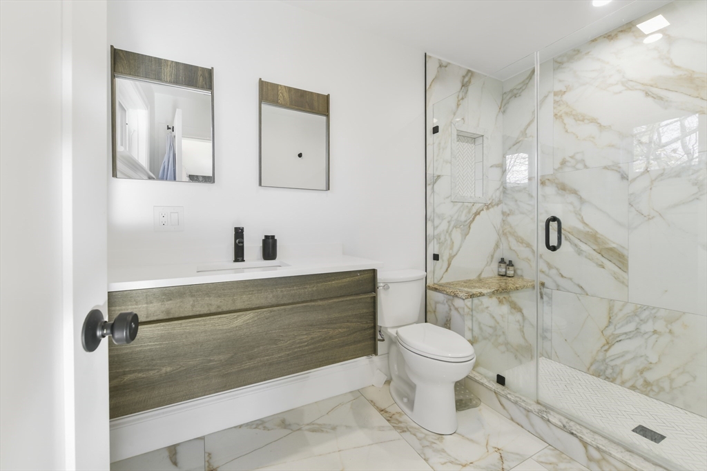 17 Akron Street, Unit 2 Boston, MA 02119 - Photo 12 of 25 a bathroom with a sink toilet and shower