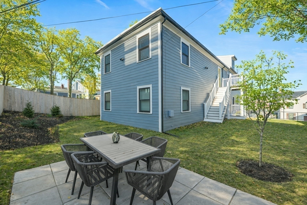 17 Akron Street, Unit 2 Boston, MA 02119 - Photo 19 of 25 a backyard of a house with table and chairs