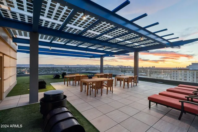 a roof deck with a table and chairs