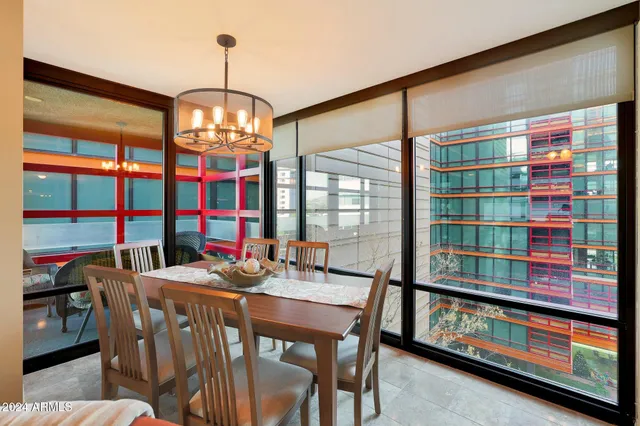 a dining room with furniture a chandelier and window