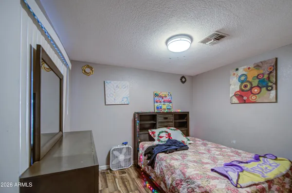 a bedroom with a bed and a table