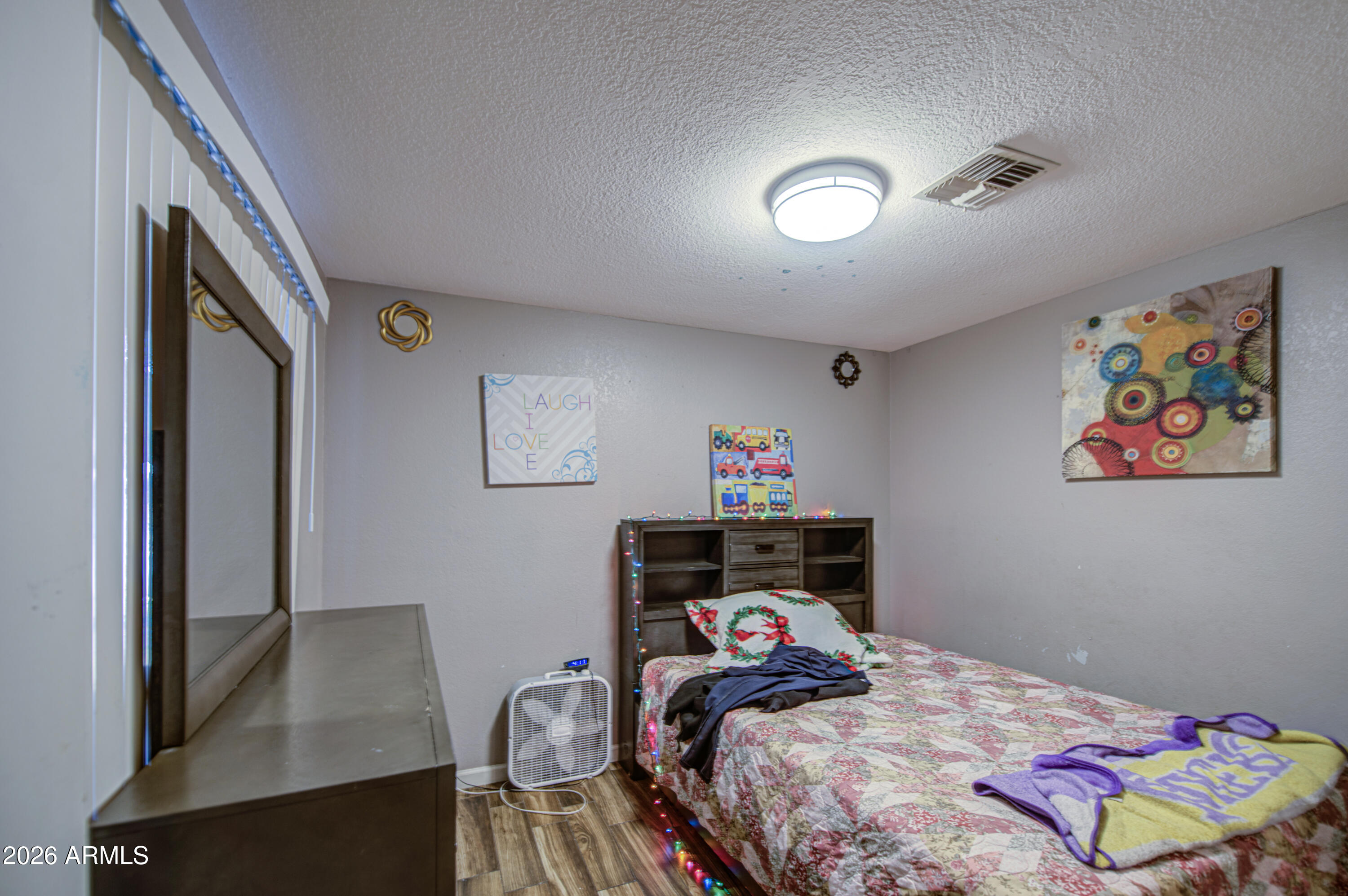 9009 West Elm Street, Unit 6 Phoenix, AZ 85037 - Photo 13 of 23 a bedroom with a bed and furniture