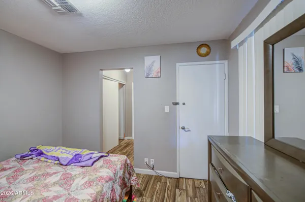 a bedroom with a bed and a dresser in it