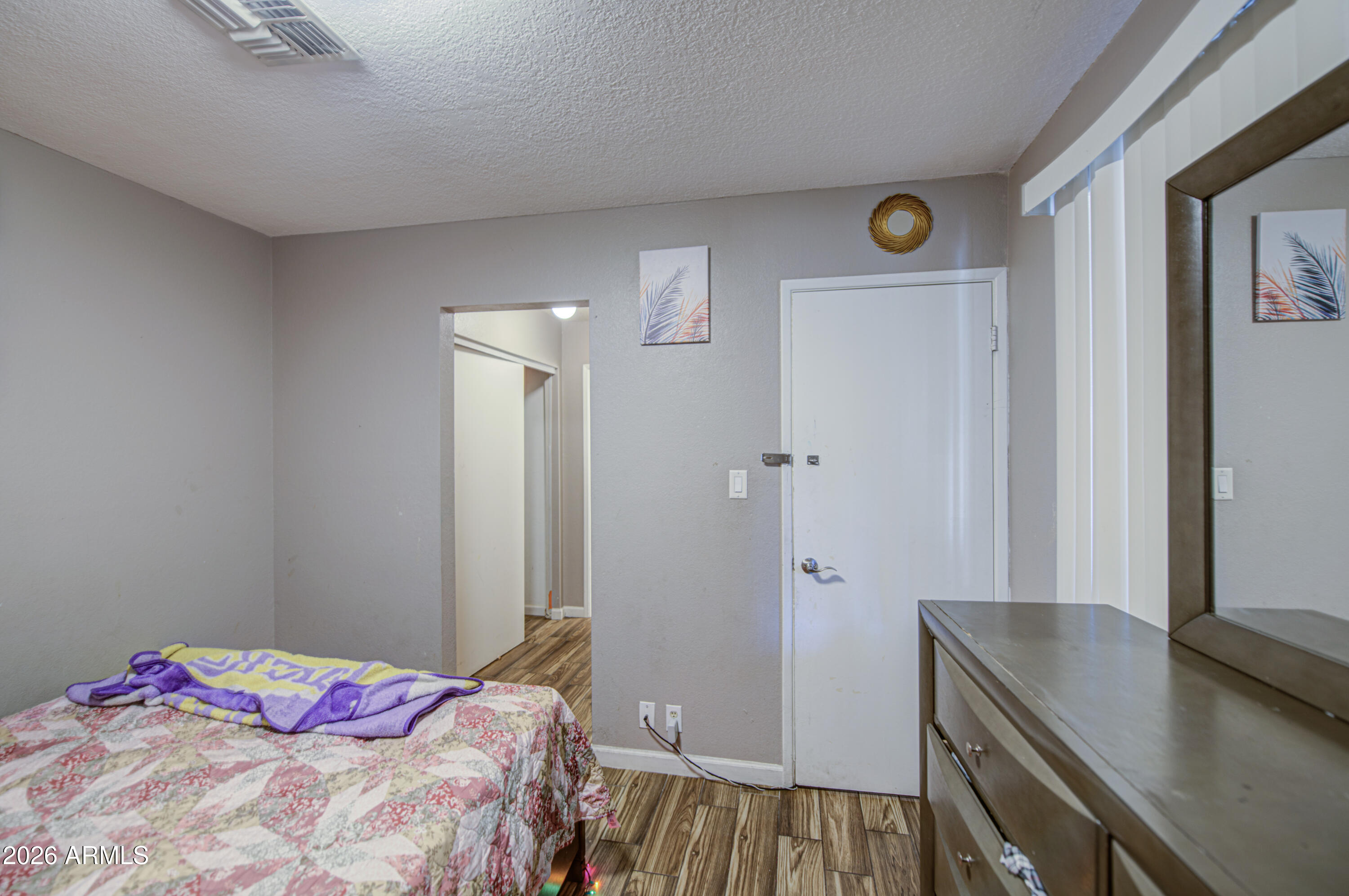 9009 West Elm Street, Unit 6 Phoenix, AZ 85037 - Photo 14 of 23 a bedroom with a bed and a table