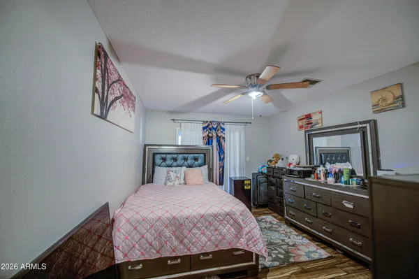 a bedroom with a bed and a dresser