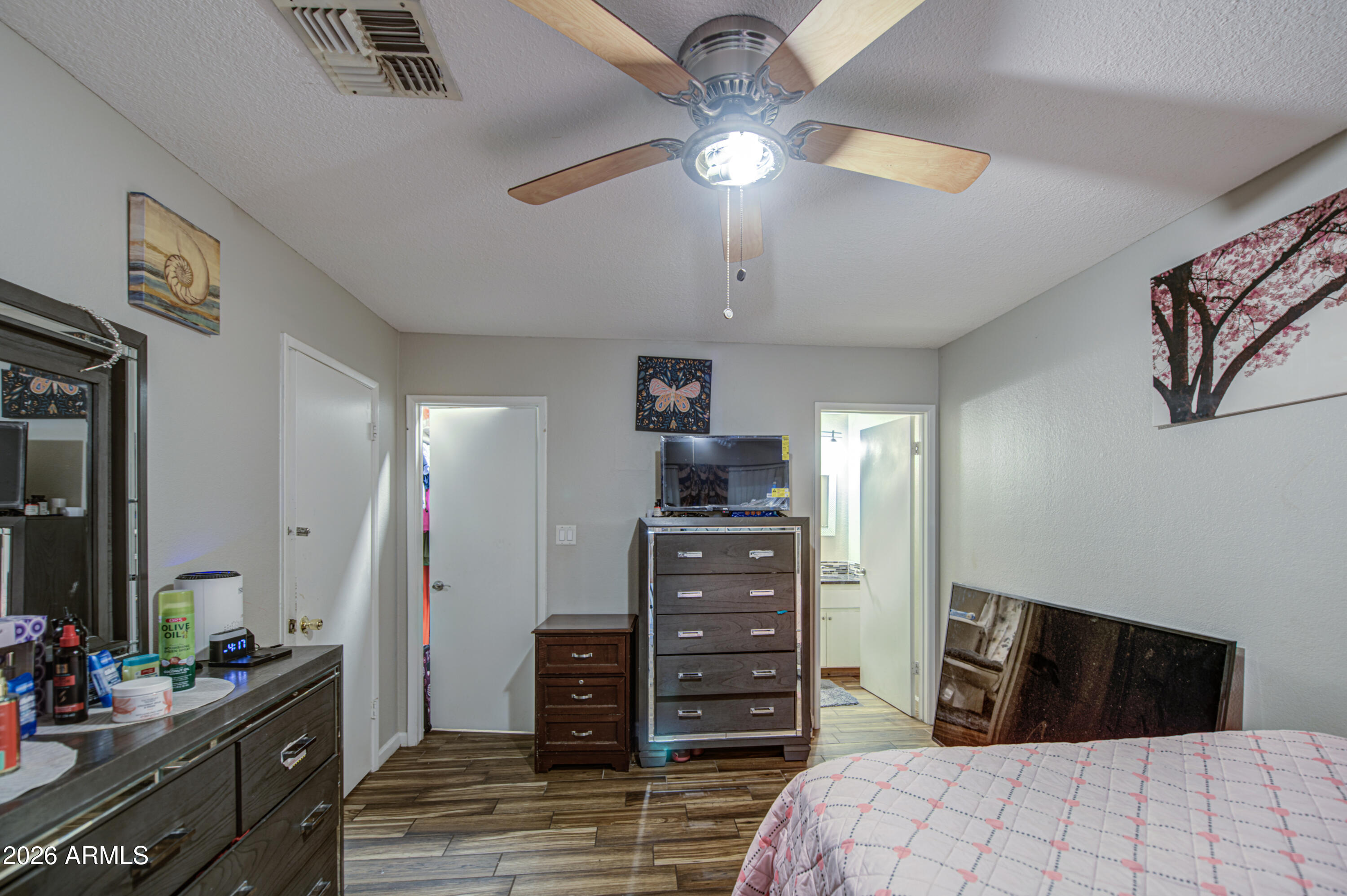 9009 West Elm Street, Unit 6 Phoenix, AZ 85037 - Photo 16 of 23 a bedroom with a bed and a dresser