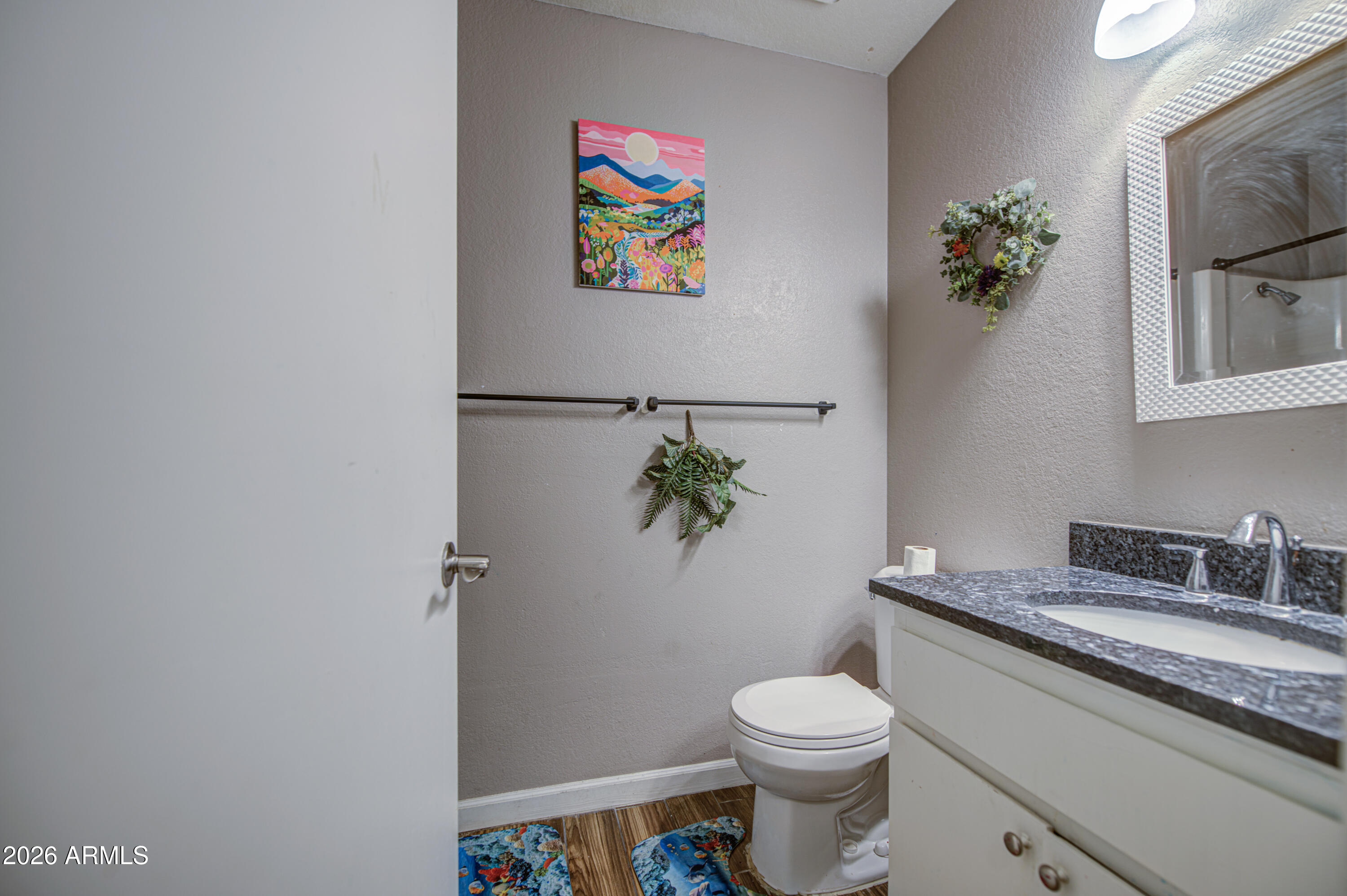 9009 West Elm Street, Unit 6 Phoenix, AZ 85037 - Photo 17 of 23 a white toilet sitting next to a bathroom sink