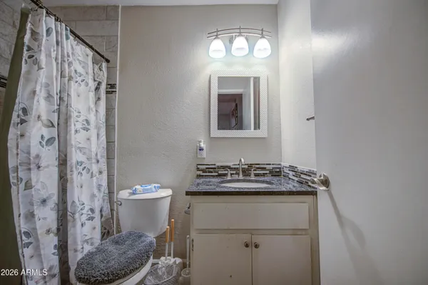 a bathroom with a toilet sink and shower