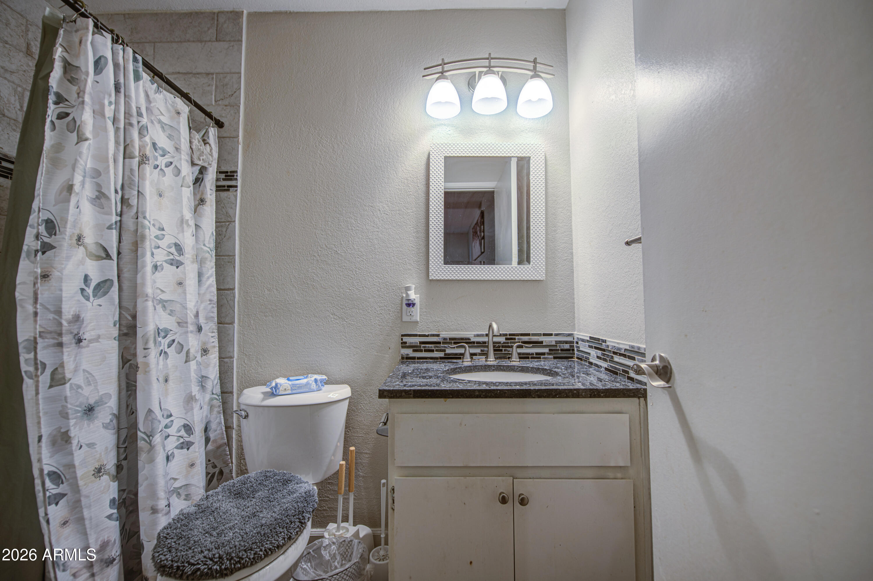 9009 West Elm Street, Unit 6 Phoenix, AZ 85037 - Photo 20 of 23 a bathroom with a sink toilet and shower
