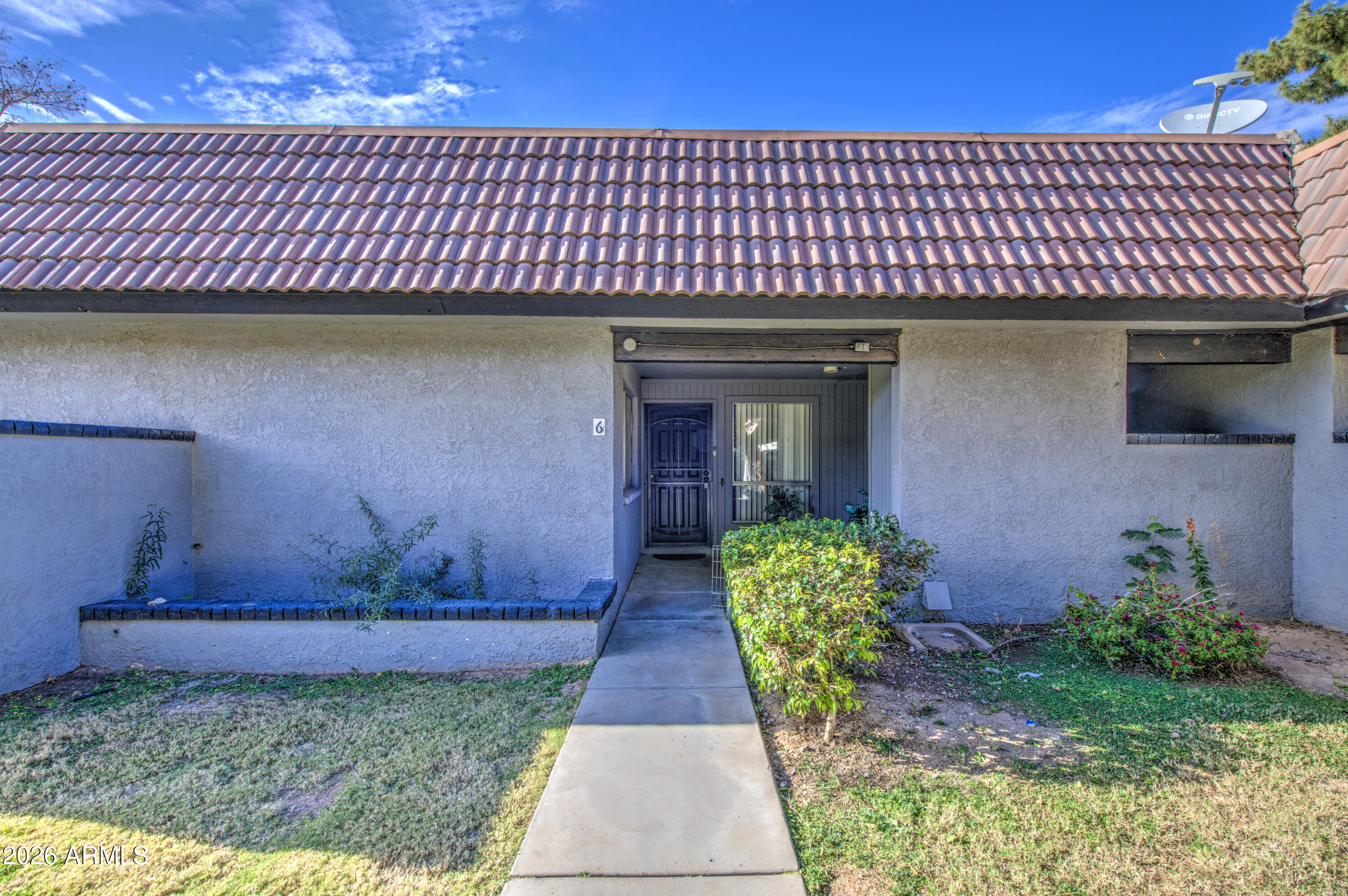 9009 West Elm Street, Unit 6 Phoenix, AZ 85037 - Photo 3 of 23 a front view of a house with garden