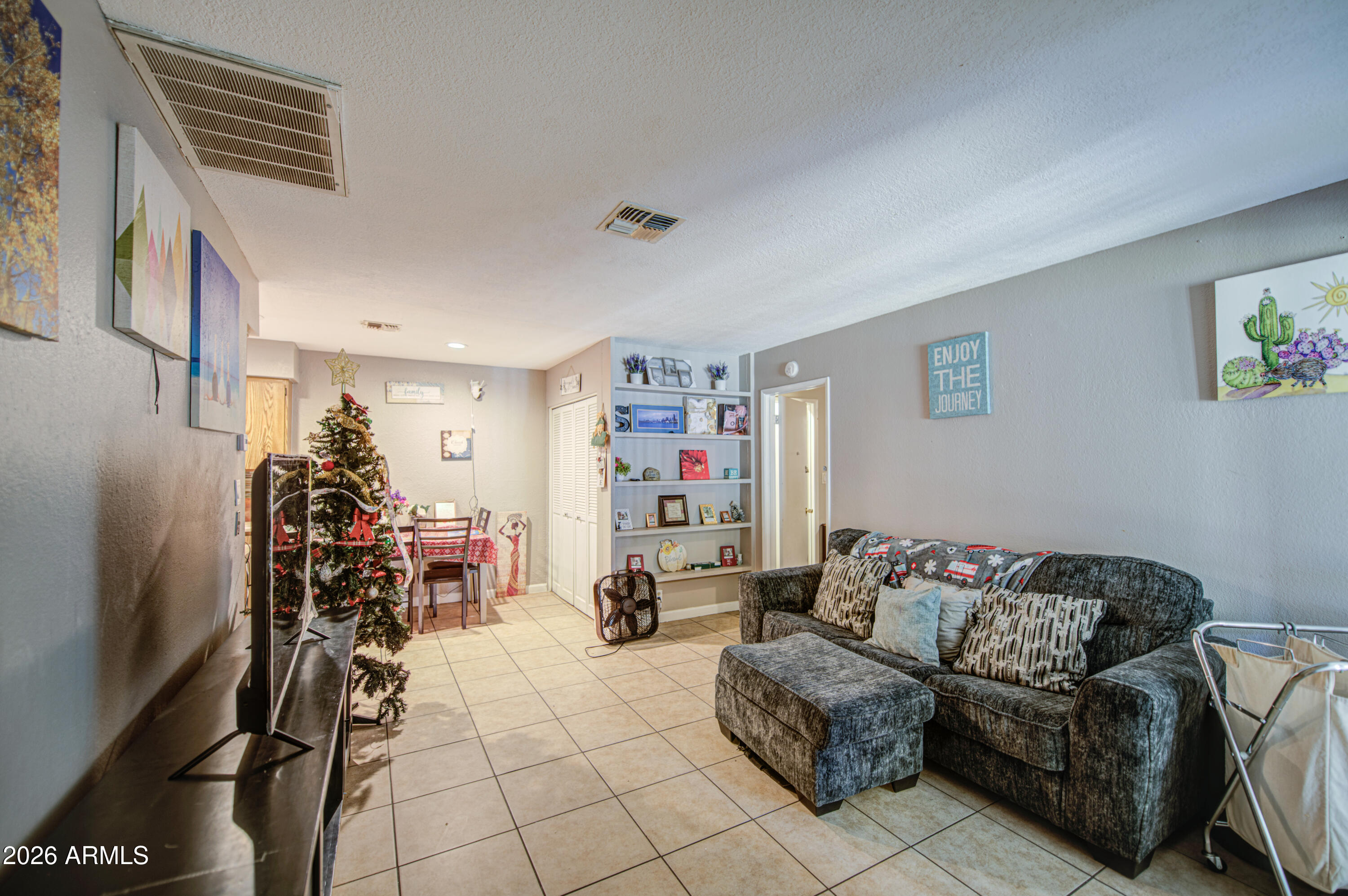 9009 West Elm Street, Unit 6 Phoenix, AZ 85037 - Photo 4 of 23 a living room with furniture and a flat screen tv