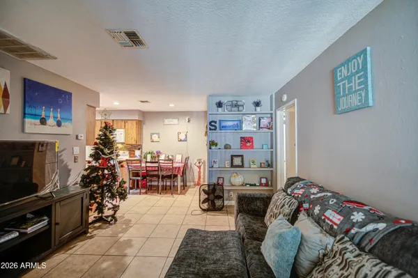 a bedroom with furniture and a flat screen tv