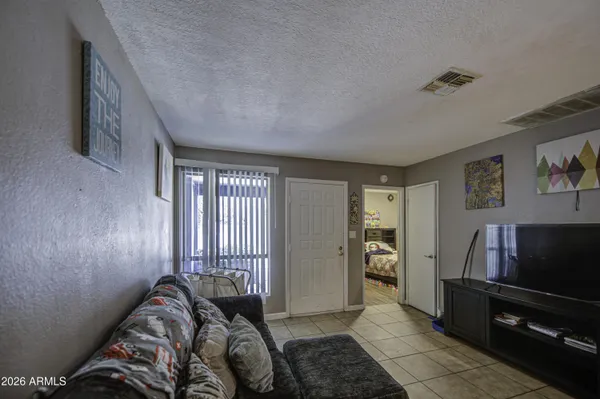 a bedroom with furniture and a flat screen tv