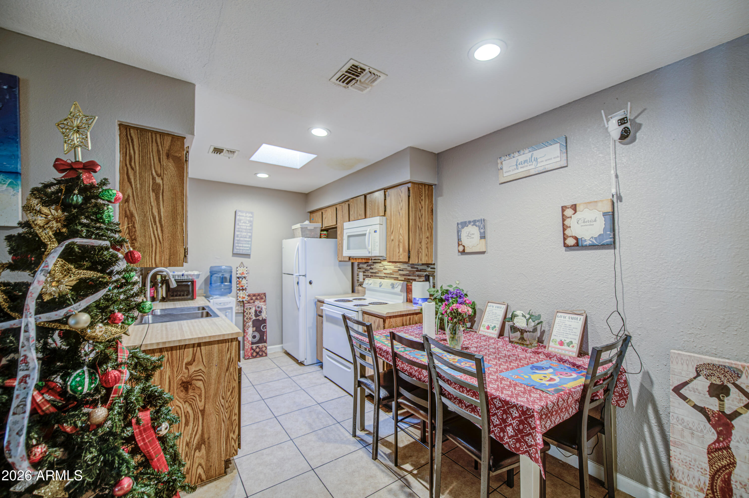 9009 West Elm Street, Unit 6 Phoenix, AZ 85037 - Photo 9 of 23 a view of a dining room with furniture and a potted plant