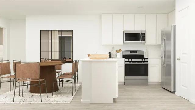 a kitchen with stainless steel appliances kitchen island granite countertop a stove top oven microwave and cabinets