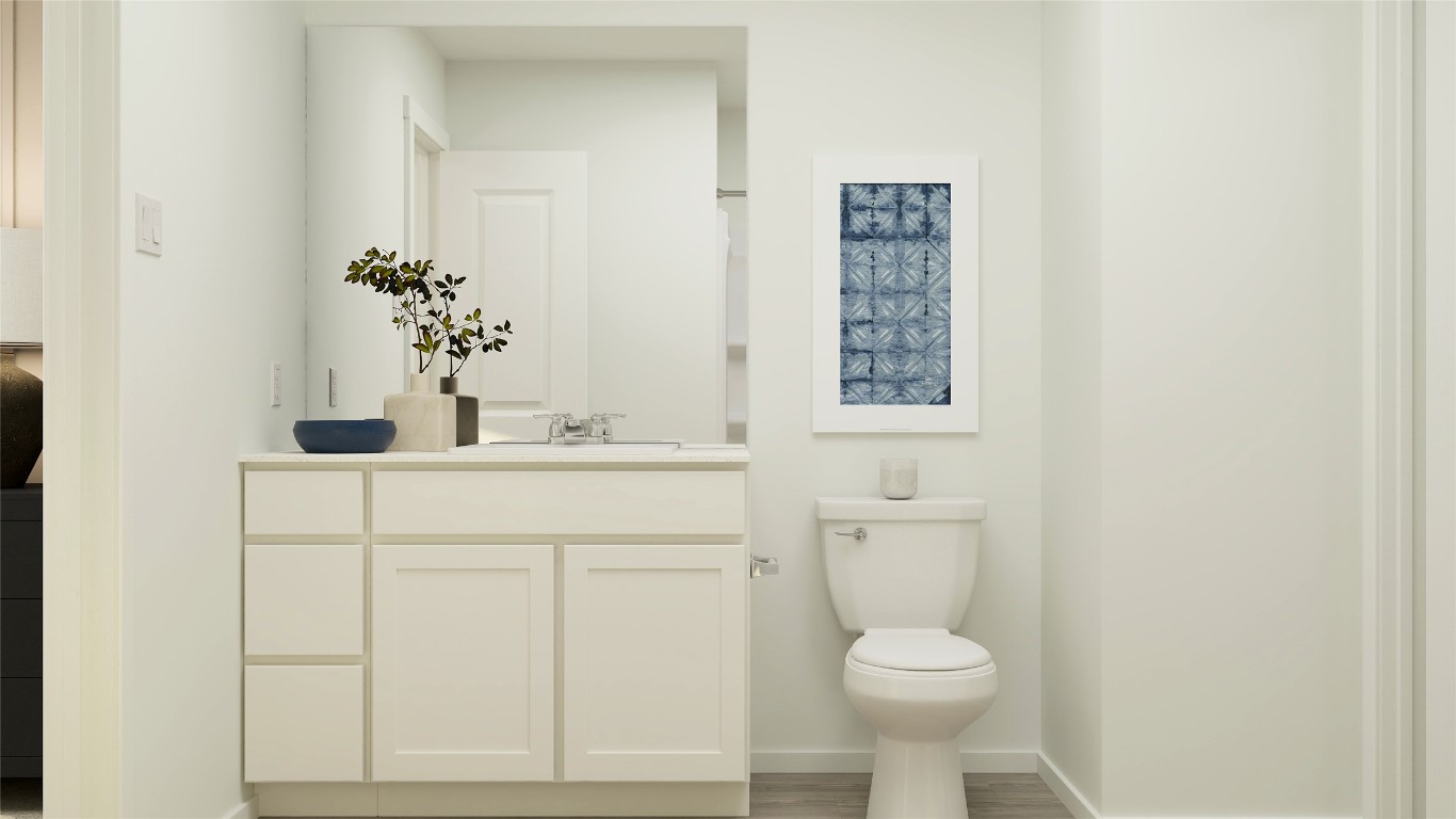 242 Kings Row Lane Jarrell, TX 76537 - Photo 22 of 25 a bathroom with a sink a toilet and a mirror
