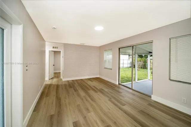 a view of an empty room with glass door