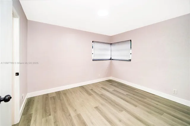 a view of a room with wooden floor