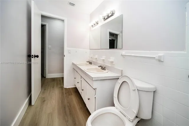 a utility room with cabinets washer and dryer