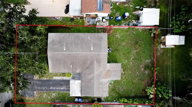 an aerial view of a house with a garden and a yard
