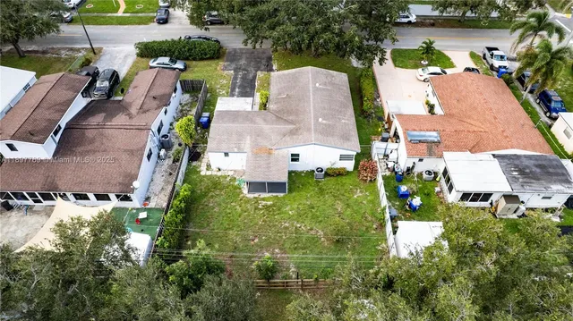 an aerial view of multiple houses with yard