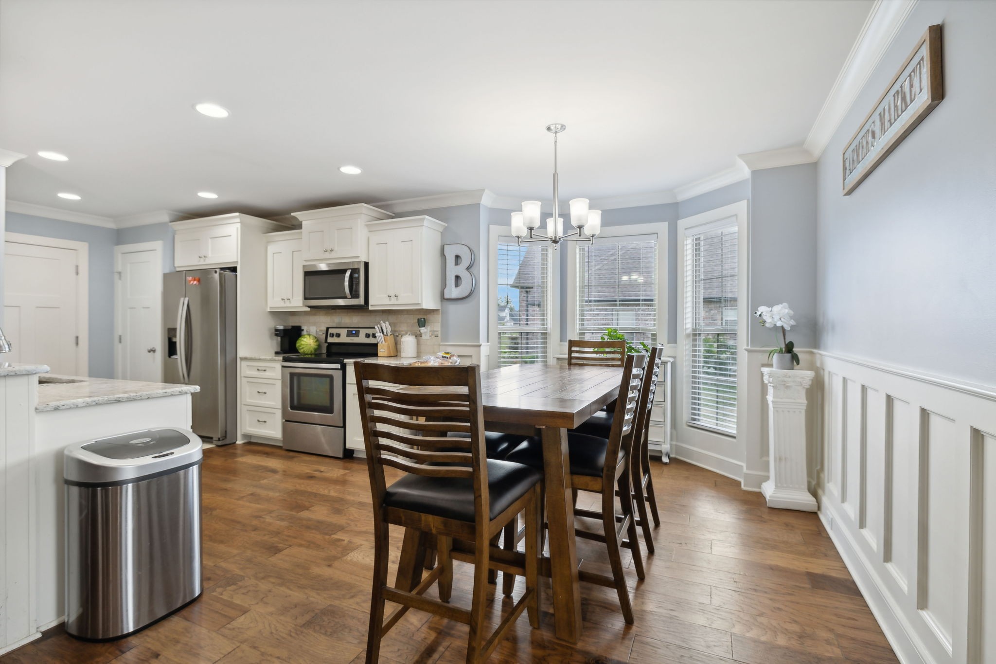 101 Flat Woods Road Lebanon, TN 37090 - Photo 20 of 55 a kitchen with stainless steel appliances kitchen island granite countertop a table chairs and a refrigerator