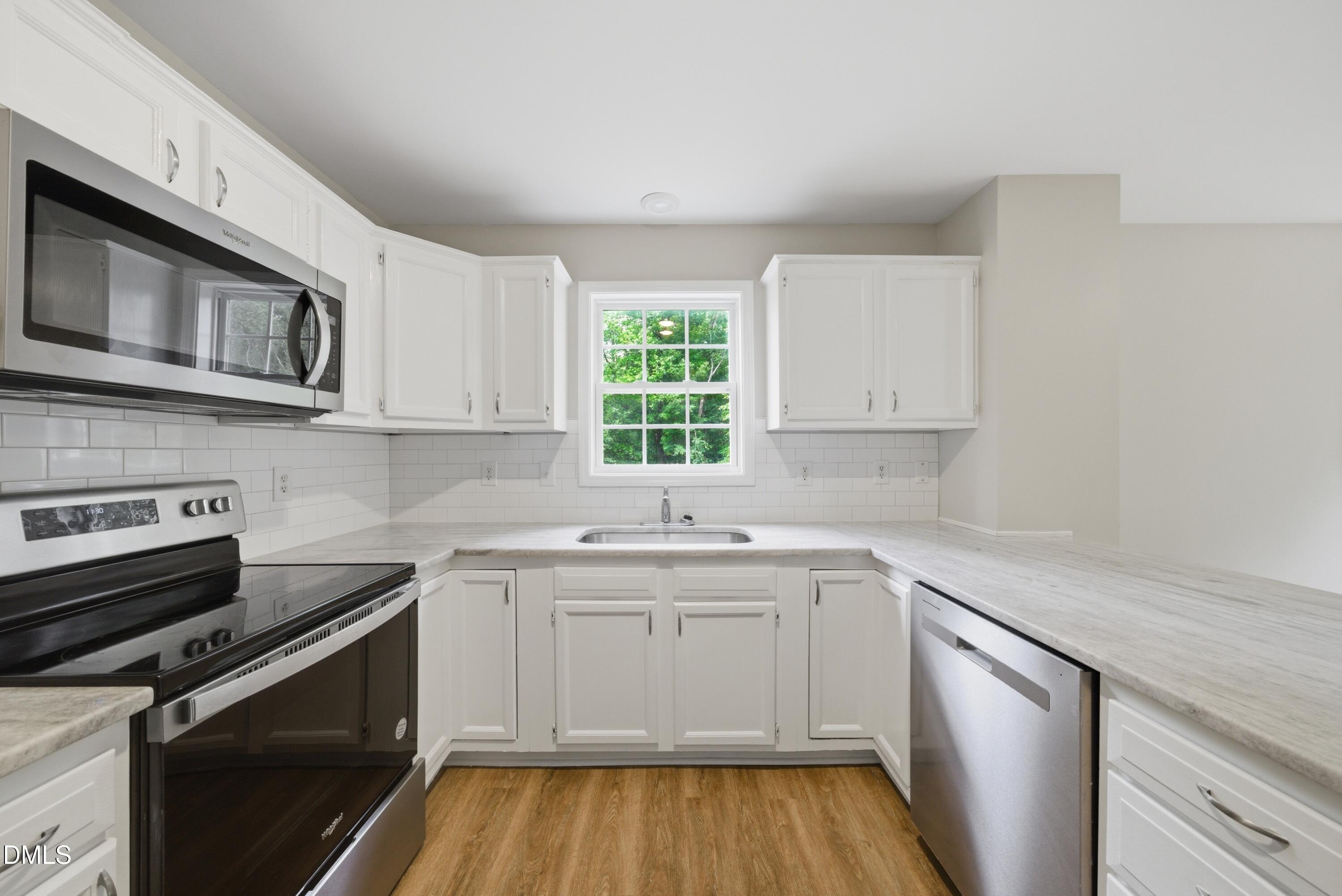 201 Tonylee Court, Unit A Raleigh, NC 27603 - Photo 12 of 30 a kitchen with a sink stove and microwave
