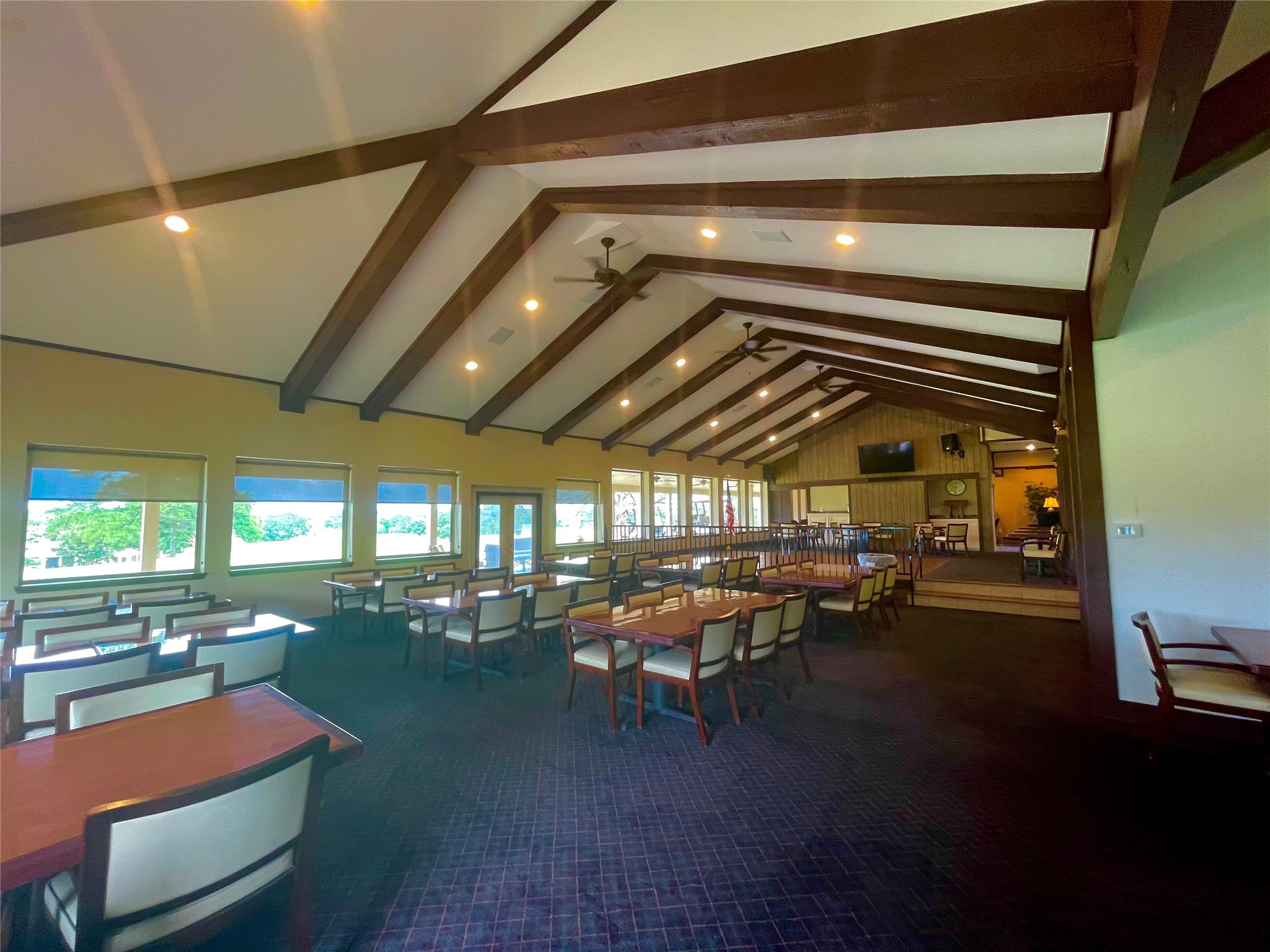 106 Westlake Road Trinity, TX 75862 - Photo 23 of 36 This spacious dining area features high ceilings with exposed beams, ample seating, and large windows providing plenty of natural light and scenic views. Ideal for gatherings and entertaining.