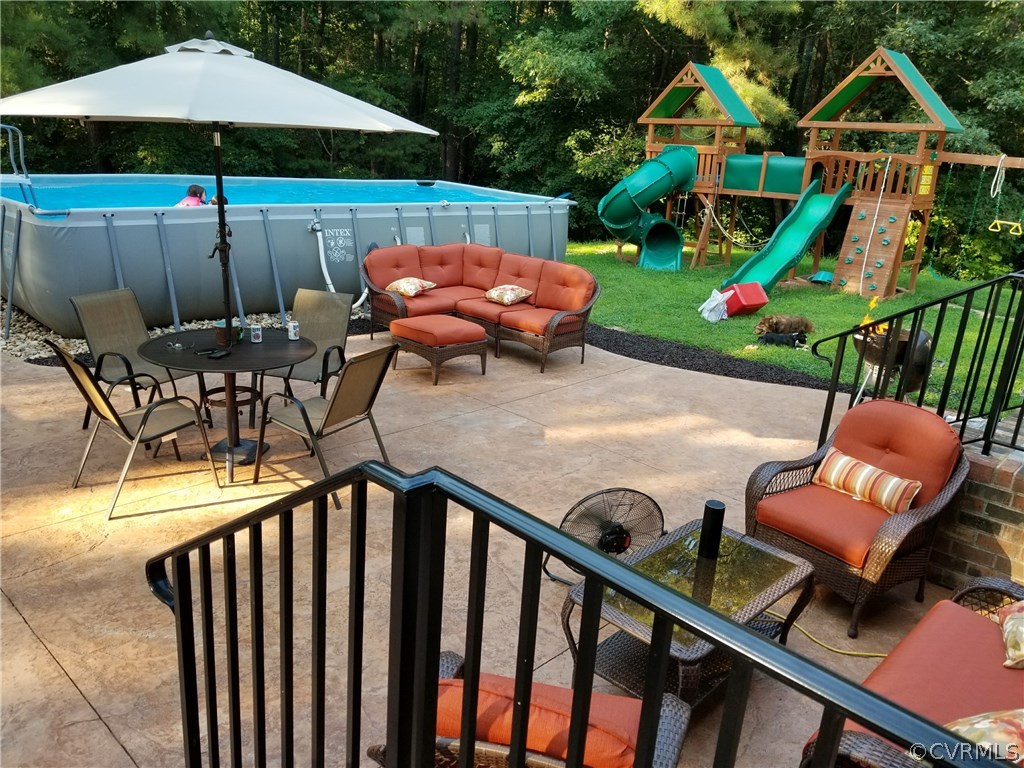 8074 Peaks Road Hanover, VA 23069 - Photo 15 of 28 a view of a chairs and table in the patio with a barbeque grill