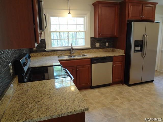 8074 Peaks Road Hanover, VA 23069 - Photo 6 of 28 a kitchen with stainless steel appliances granite countertop a stove a sink and a refrigerator