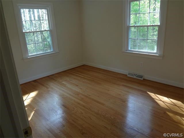 8074 Peaks Road Hanover, VA 23069 - Photo 8 of 28 an empty room with wooden floor and windows