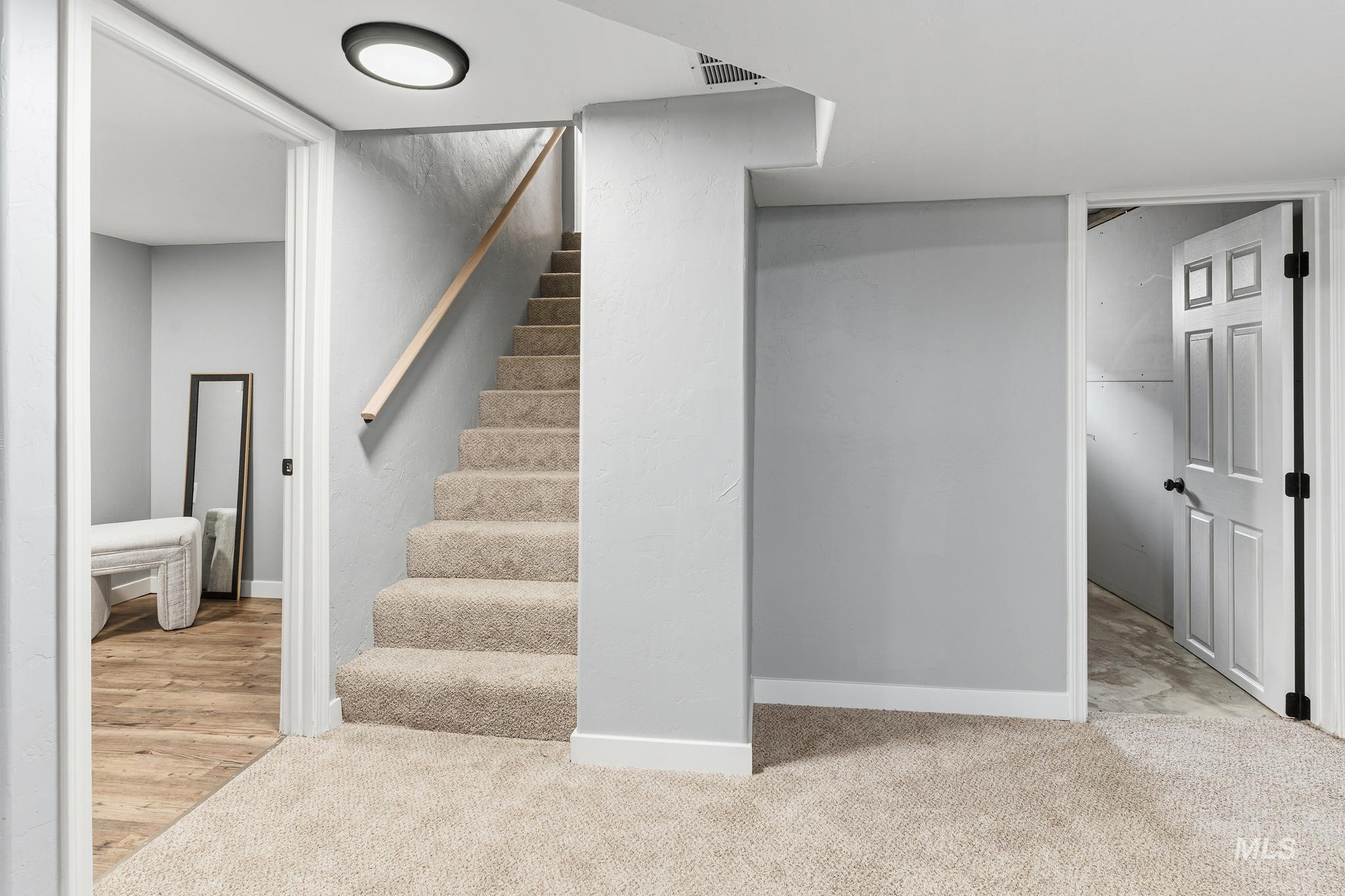 619 Thain Road Lewiston, ID 83501 - Photo 19 of 44 Carpeted staircase featuring a light wood-finish handrail