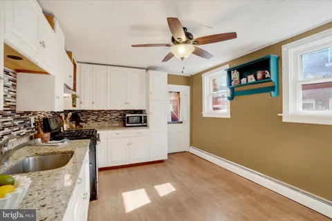 a kitchen with stainless steel appliances a stove a microwave and a refrigerator