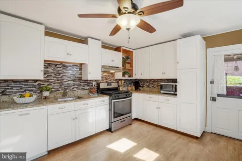 a kitchen with a sink cabinets and window