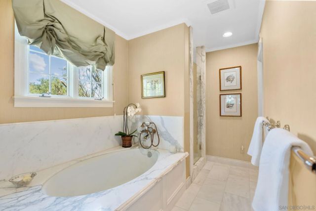 a bathroom with a tub and a shower