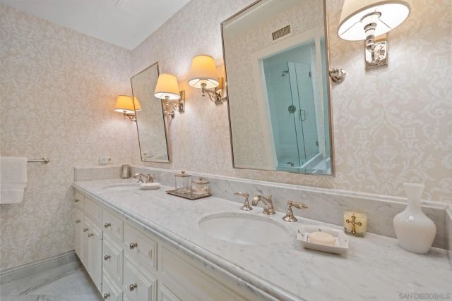 a bathroom with a double vanity sink and a mirror