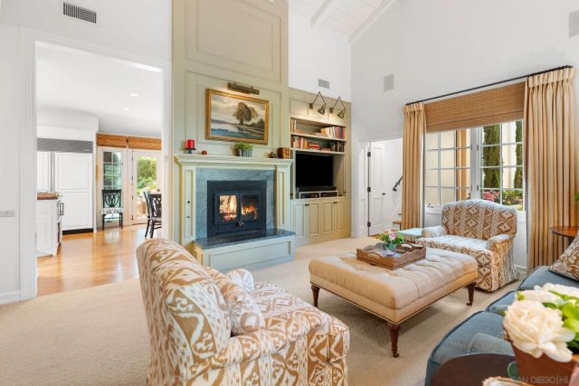 a living room with furniture flat screen tv and a fireplace
