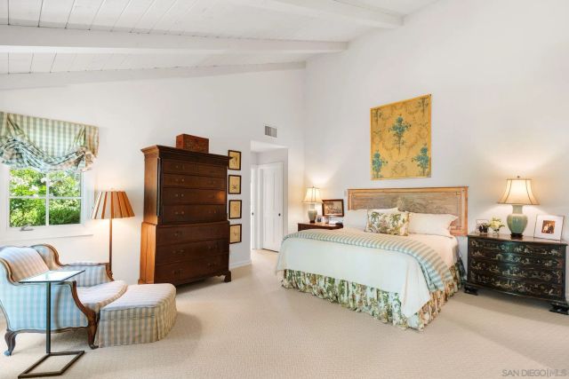 a spacious bedroom with a bed and a couch