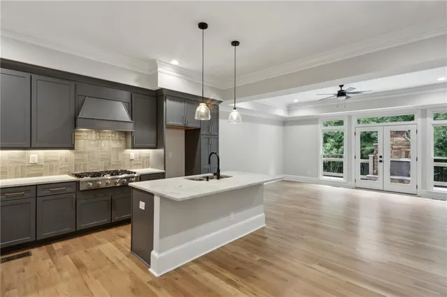 a kitchen with stainless steel appliances granite countertop a sink stove and refrigerator