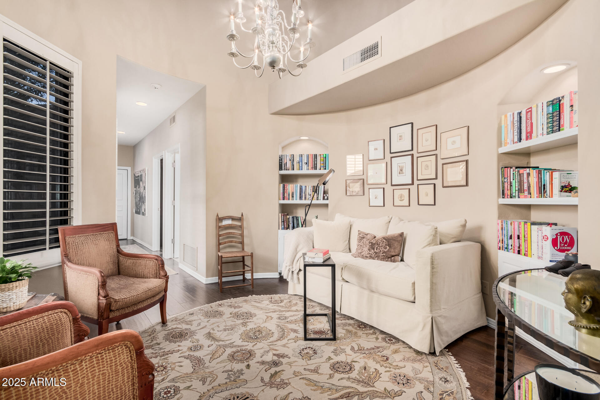 7878 East Gainey Ranch Road, Unit 41 Scottsdale, AZ 85258 - Photo 29 of 46 a living room with furniture and a book shelf