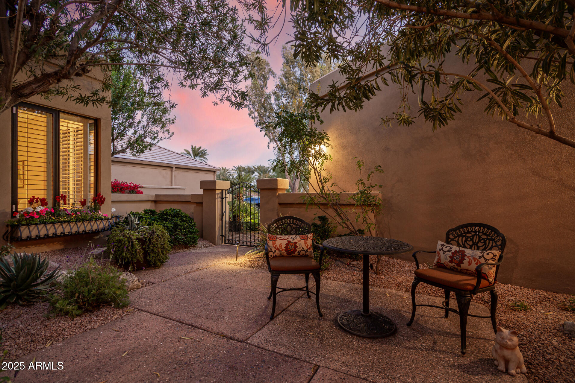 7878 East Gainey Ranch Road, Unit 41 Scottsdale, AZ 85258 - Photo 2 of 46 a backyard of a house with table and chairs