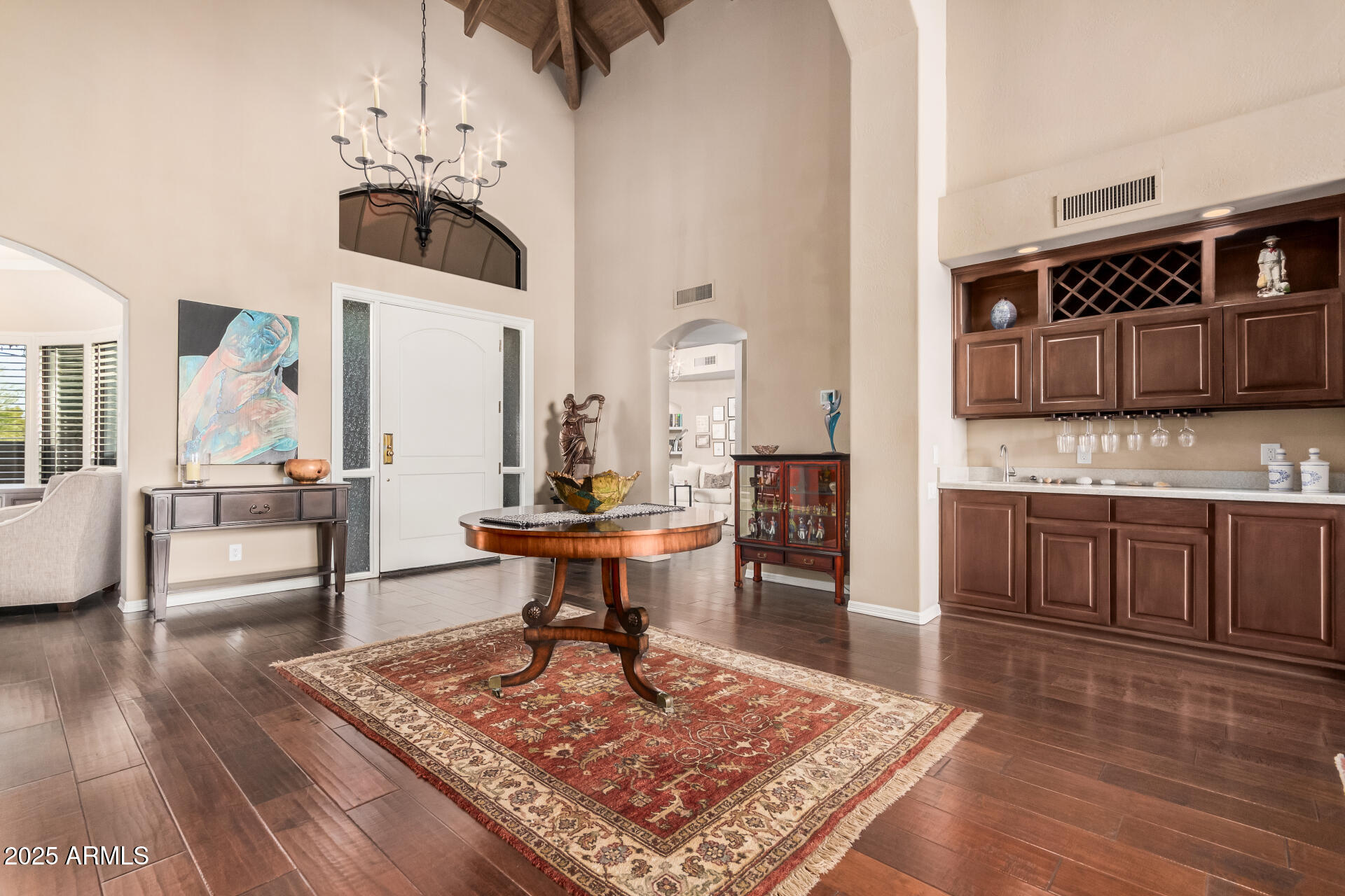 7878 East Gainey Ranch Road, Unit 41 Scottsdale, AZ 85258 - Photo 6 of 46 a living room with stainless steel appliances kitchen island granite countertop a rug a stove a sink and a dining table with wooden floor