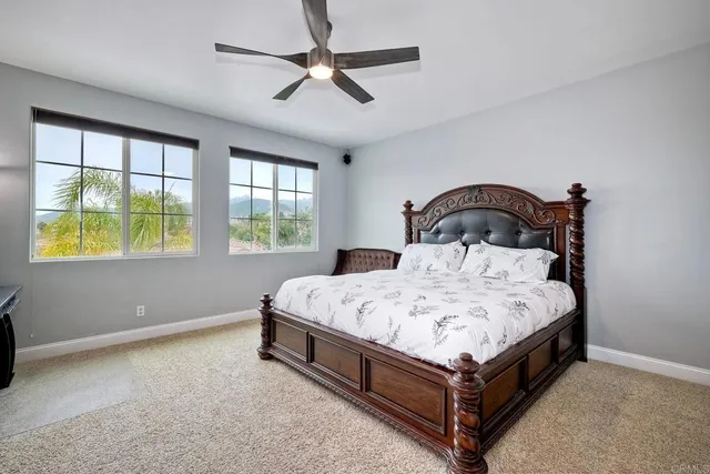 a bed sitting in a bedroom next to a window