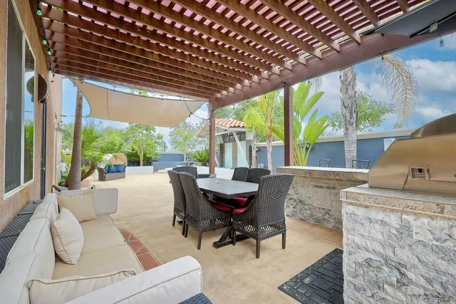 a dining room with furniture and large windows