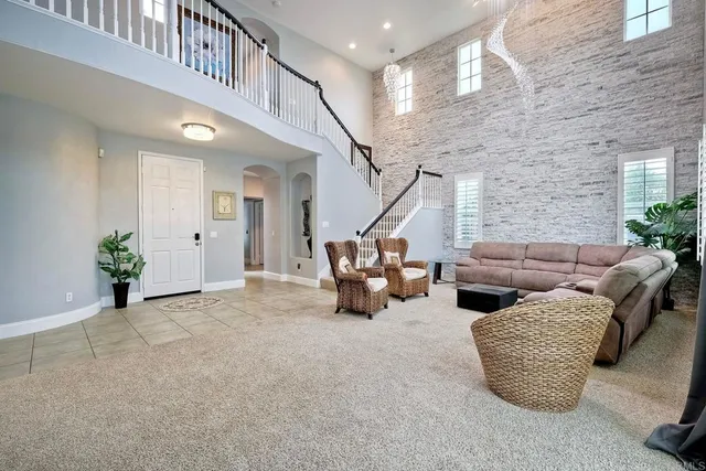 a living room with furniture and stairs