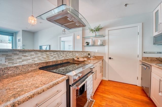 a kitchen with a sink stove and refrigerator