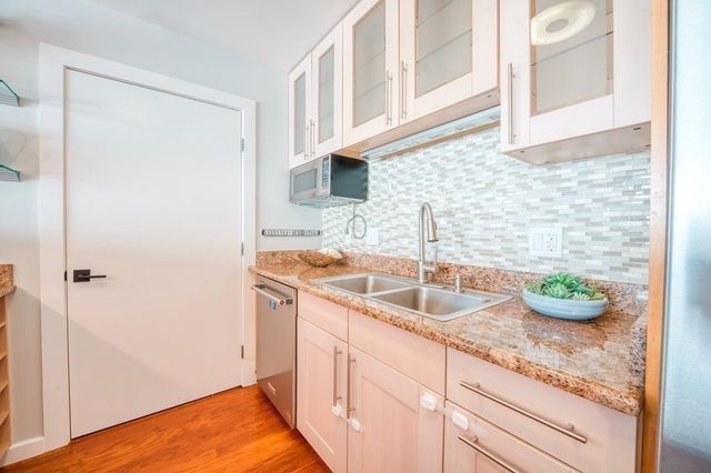 a kitchen with a sink and cabinets