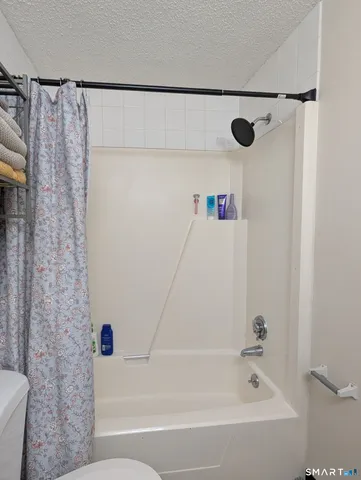 a bathroom with a bathtub and shower