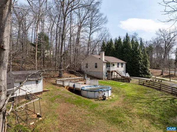 a view of a house with a wooden fence